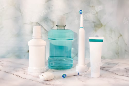 Preview: Electric toothbrush, floss, toothpaste tube and mouthwash, dental hygiene and oral care kit.
