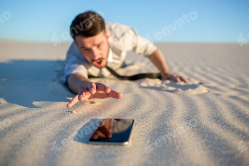 Preview: Poor Signal. Frustrated Young Businessman Searching For Mobile Phone Signal While Lying On Sand In