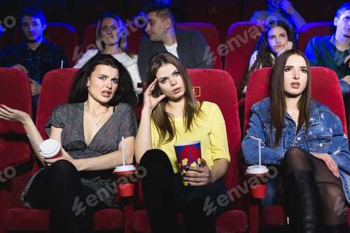 Preview: Girls watching a really boring movie at the cinema theater. Bad film