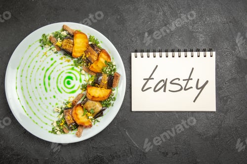 Preview: top view cooked eggplant rolls with potatoes and along with tasty writing on the dark background