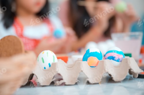Preview: mother and child family making waster egg at home happy and fun together in holiday