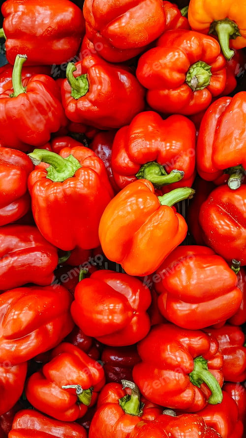 Preview: Fresh red sweet bell peppers on the market. Top view, background.
