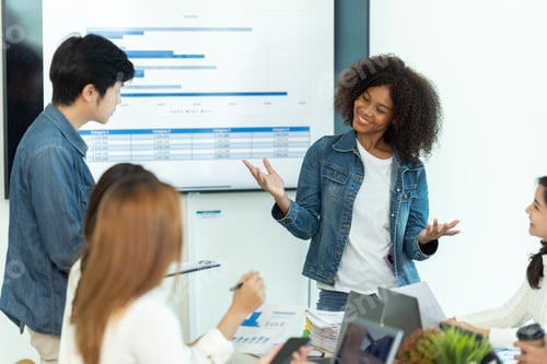 Preview: Business people showing team work while working in board room in office interior