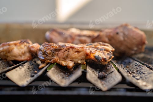Preview: Chicken pieces grilling on barbecue for a delicious meal