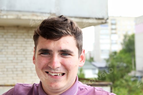 Preview: A young Caucasian man 18-29 years old, with a genuine smile revealing slightly crooked teeth