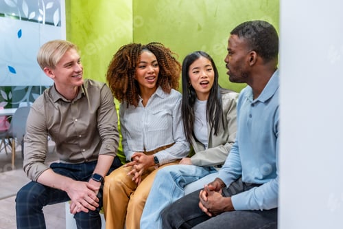 Preview: Diverse colleagues engaging in collaborative discussion in coworking space