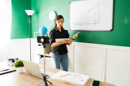 Preview: Teacher with glasses teaching algebra