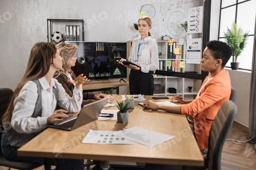 Preview: Multiracial female business people having briefing about financial situation at company.