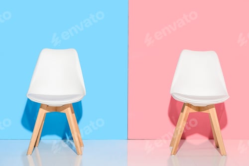 Preview: close up view of white chairs against blue and pink wall