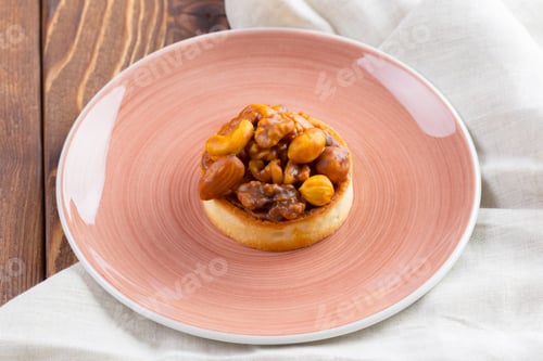Preview: Tart with nuts on pink plate close up