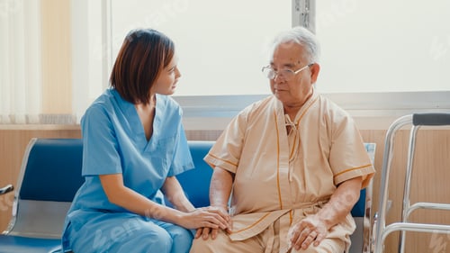 Preview: Caring Young Woman Nurse Holds Senior Man's Hand