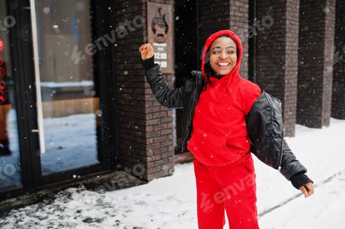 Preview: African american woman in red hoodie enjoy winter day.