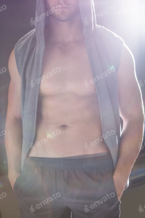 Preview: Muscular man with hands in his pocket in crossfit gym