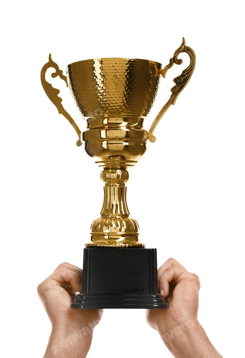 Preview: Young man holding gold trophy cup on white background, closeup