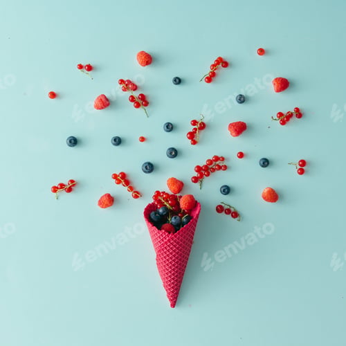 Preview: Forest fruit with ice cream cone on blue pastel background. Flat lay. Summer concept.
