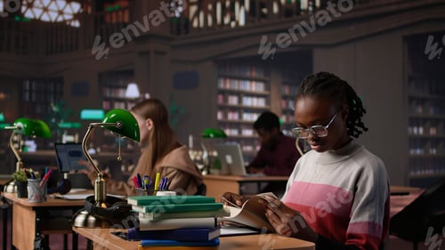 Preview: Black girl reading books and handwritten class notes right before the exam