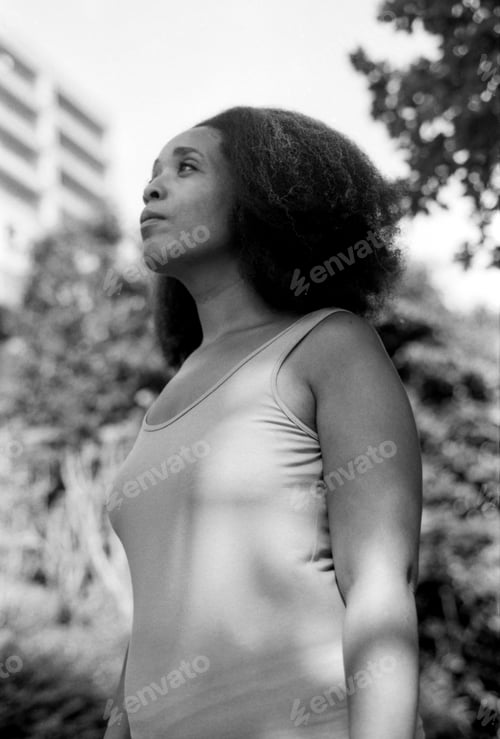 Preview: Woman looking up contemplating in black and white analog film style