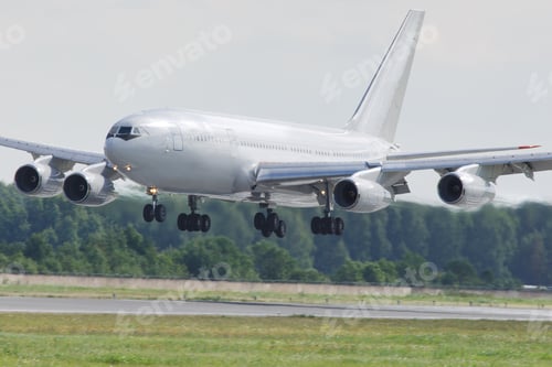 Preview: Closeup of airplane landing at international airport, low over the runway. Four-engine aircraft