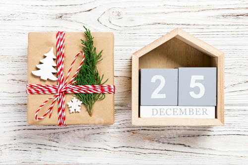 Preview: Christmas calendar 1 december. Christmas gift, fir branches on wooden white background