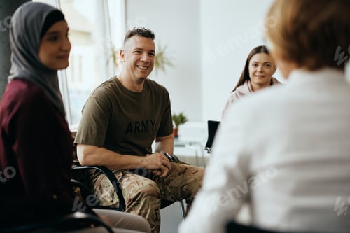 Preview: Happy military man attending group therapy at community center.