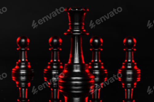 Preview: Chess pieces on dark background with red backlight close up