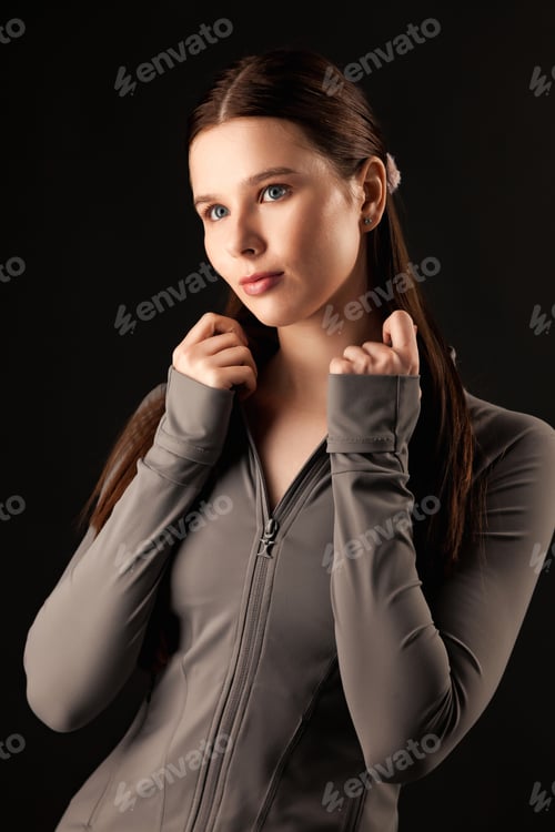 Preview: Serene Thoughtful Gaze of a Young Woman in a Studio Environment