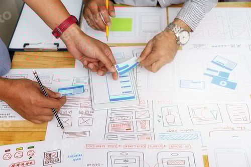 Preview: UX or UI designers designing on their smartphone application layout prototype project.