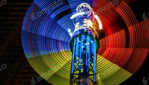 Preview: Neon lights of spinning carousel with dark sky background