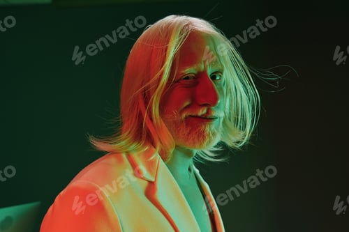 Preview: Portrait of a man with long hair in a modern suit with colorful lighting, featuring green and red