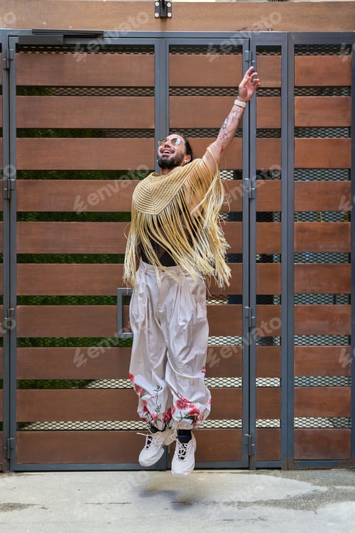 Preview: Latin transgender model jumping with happiness, celebrating pride and diversity
