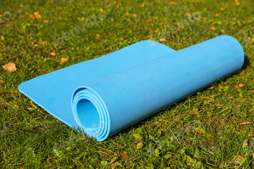 Preview: Blue karemat or fitness mat on fresh green grass outdoors