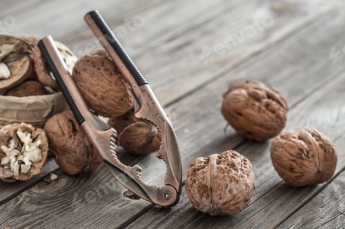 Preview: Organic Walnut lies on a wooden background , close-up .