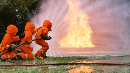 Preview: Firefighter fighting with flame using fire hose chemical water foam spray engine