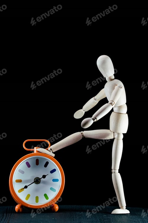 Preview: wooden dummy and analogic clock, time concept, puppet made of wood, art mennequin.Wooden Doll