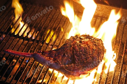 Preview: Closeup of tomahawk rib eye on a flaming grill
