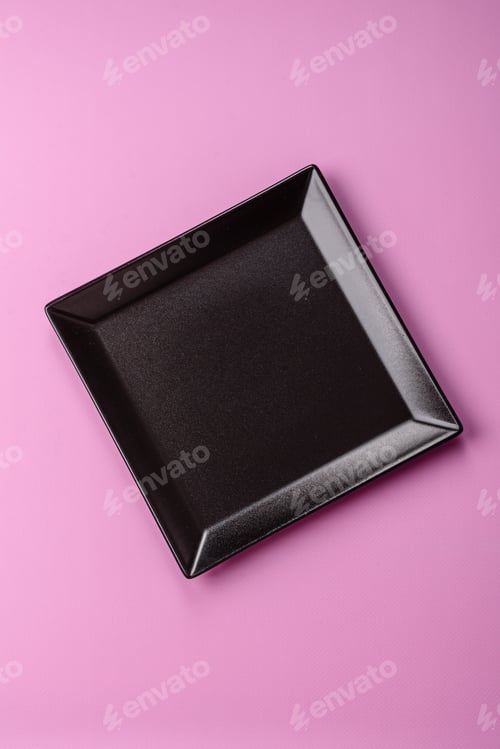 Preview: An empty round ceramic plate on a pink background as a kitchen utensil. An empty plate