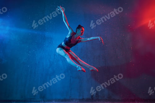 Preview: Slim ballerina jumping under rain