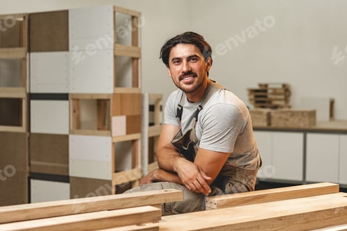 Preview: Portrait of young male carpenter standing in the wood workshop