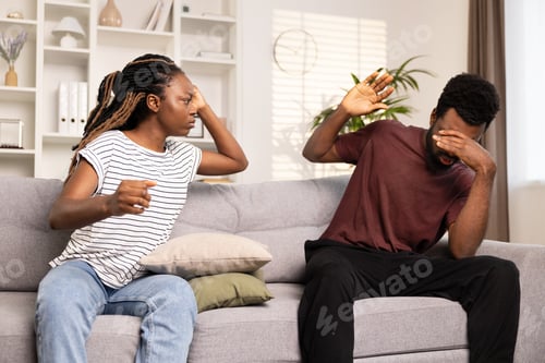 Preview: Couple Arguing On Couch At Home Showing Stress And Conflict