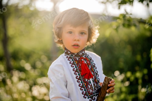Preview: Portrait of little boy with woodwind wooden flute - ukrainian sopilka. Folk music concept. Musical