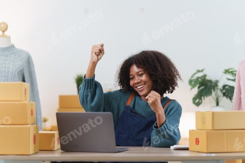 Preview: American African entrepreneur smile and checking online order. Successful SME entrepreneur concept