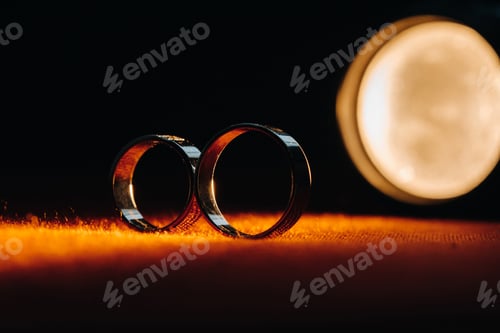 Preview: Two wedding rings on a red background. Gold rings of a couple in love.Concept of love.Wedding ring