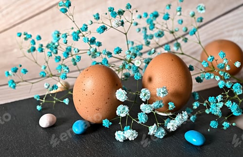 Preview: Create an Easter composition of Easter quail eggs and flowers on wooden background. A greeting card