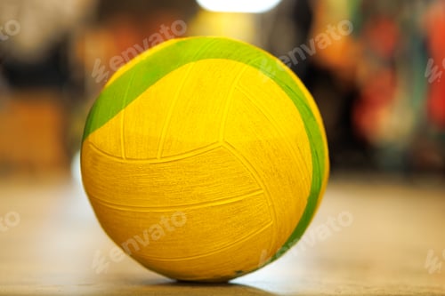 Preview: yellow-green stuffed ball on the floor in the gym on a multicolored background