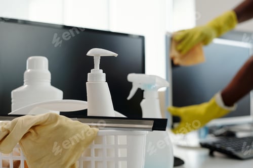 Preview: Detergents in white plastic bottles with dispensers and duster in basket