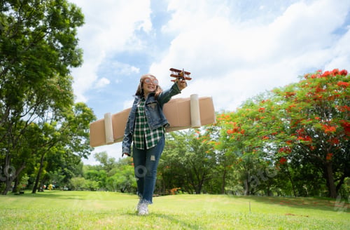 Preview: A little girl on vacation at the park with a pilot outfit and flying equipment.