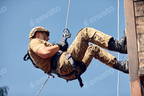 Preview: Military soldier climbing net during obstacle course in boot camp
