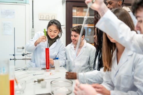 Preview: Chemistry students collaborating on experiment in university lab