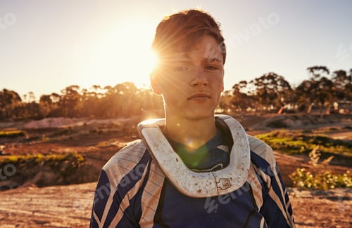Preview: Passion comes with a bit of dirt. Portrait of a dirtbike race standing in his race gear.