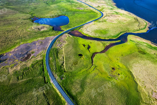 Preview: Highway road through mossy remote wilderness by coastline in summer